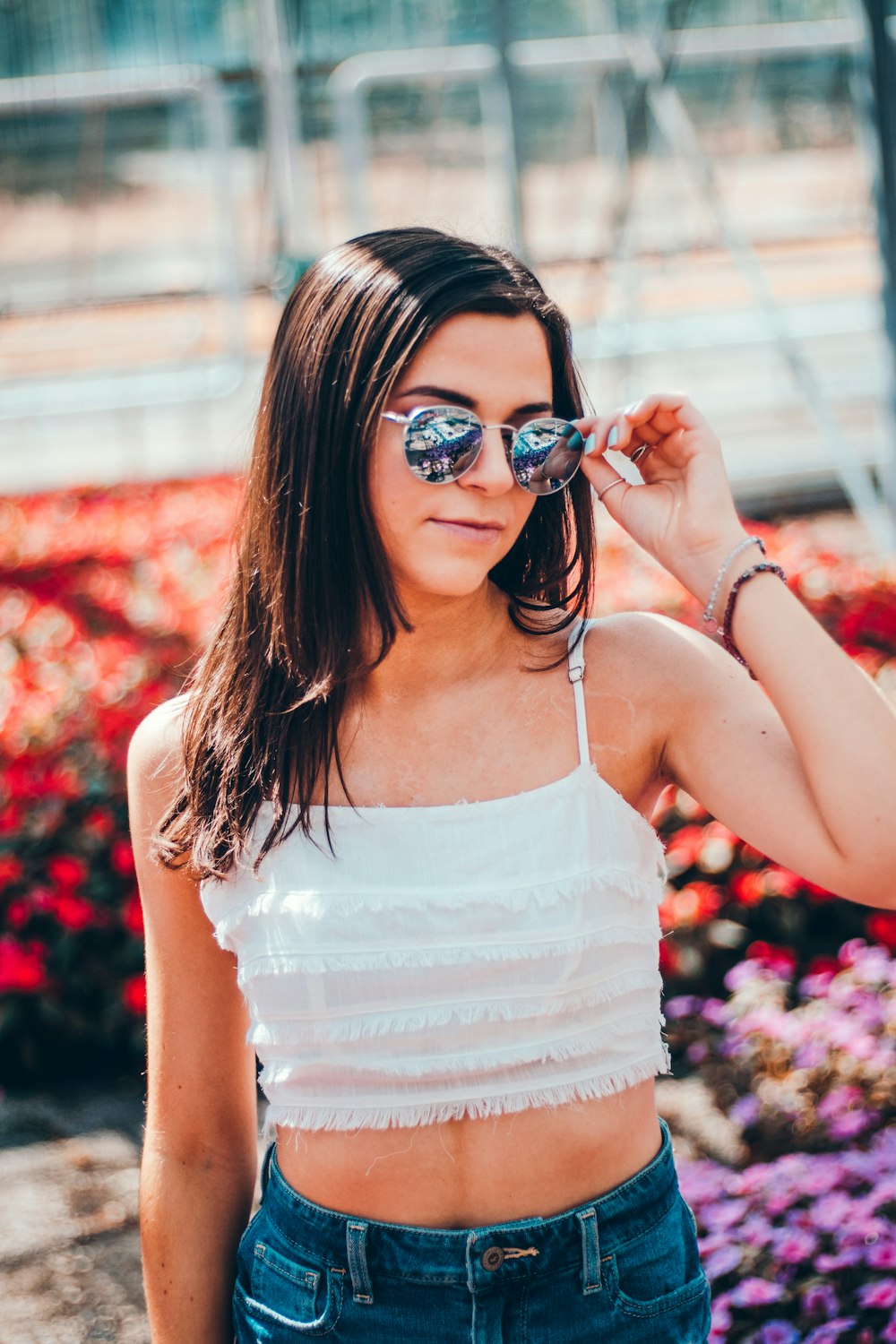 selective focus photography of woman touching aviator sunglasses