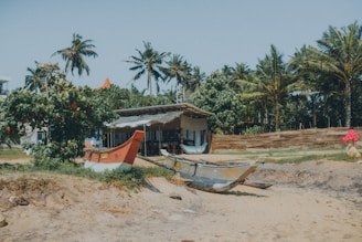 A secure parking area for caravans and boats near a sunny, sandy beach.