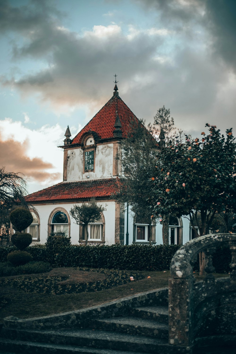 white and brown painted house surrounded with trees