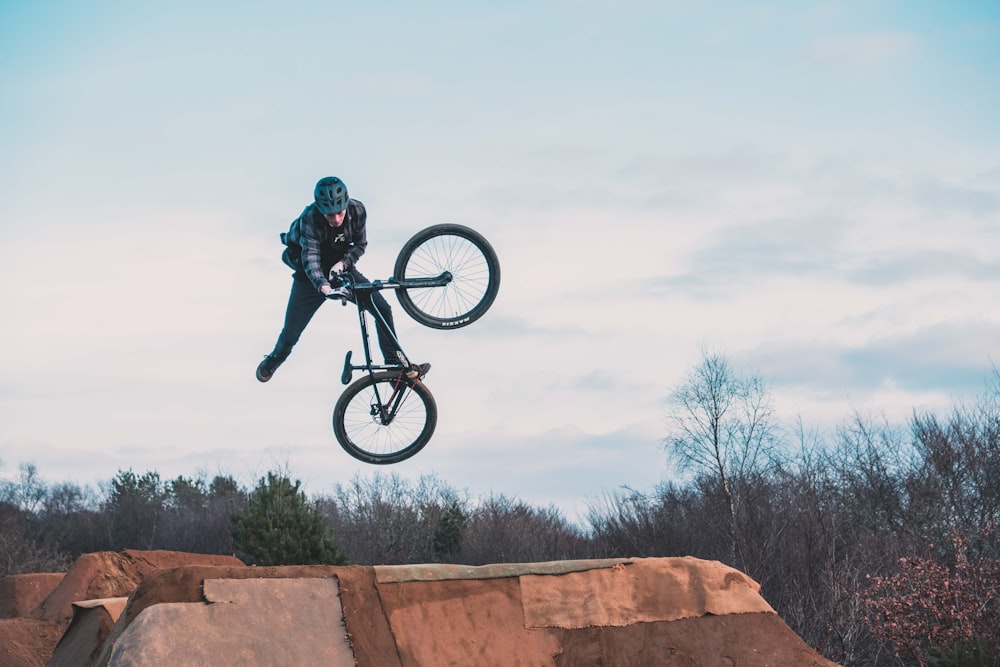 man using bicycle on mid air