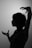 A silhouette of a person with short hair and expressive hand gestures, set against a plain background. The person's profile and hands are sharply defined, creating a dramatic contrast.