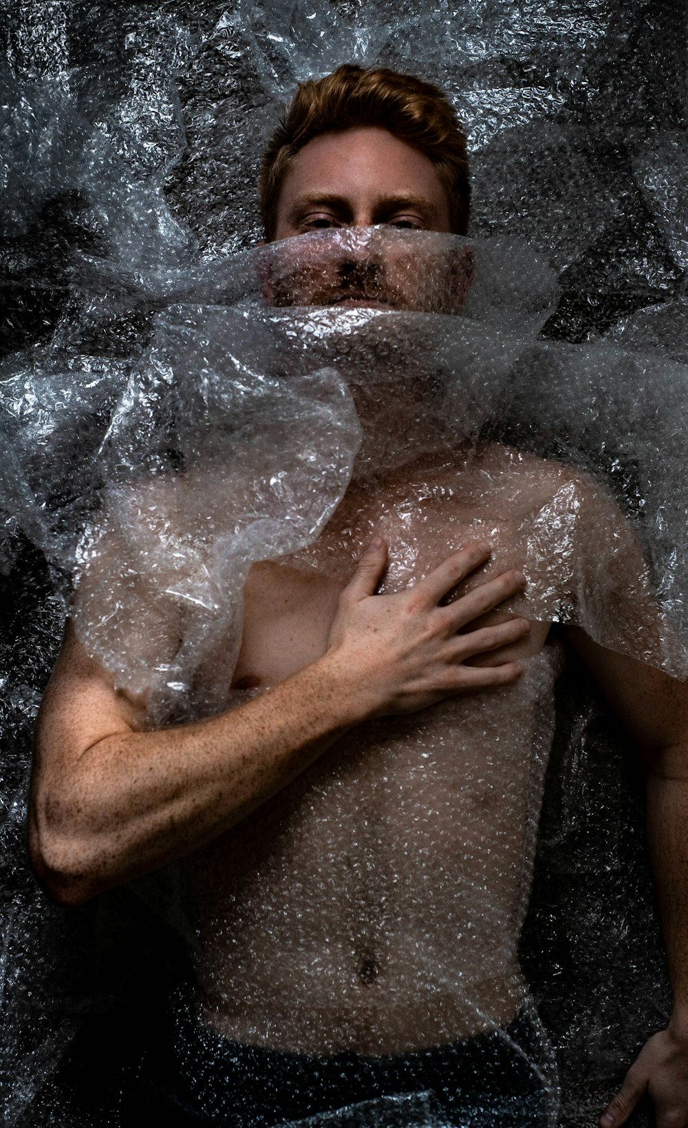 man surrounded by bubble wraps