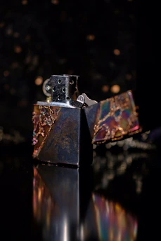 Close-up of a Dupont lighter's intricate gold detailing against a sleek black background.