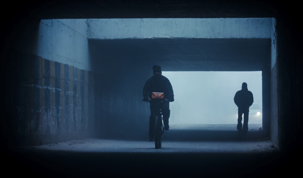 man biking on tunnel