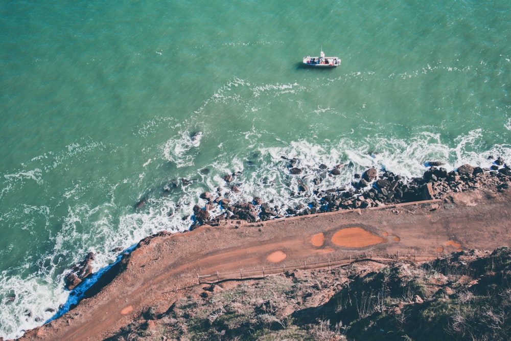 splashing of waves on rock formation during daytime