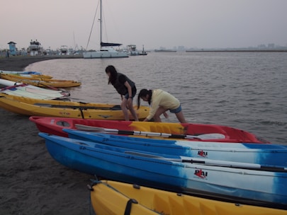 Colorful kayaks lined up on the shore ready for rental.