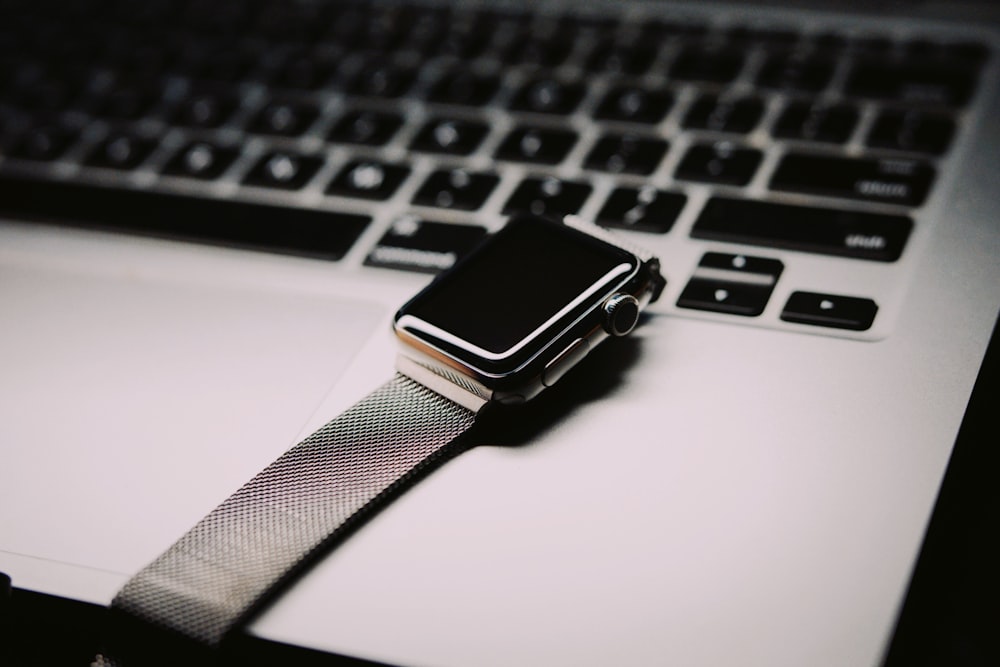 space gray Apple watch with silver mesh band