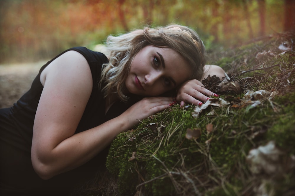 woman lying on green grass