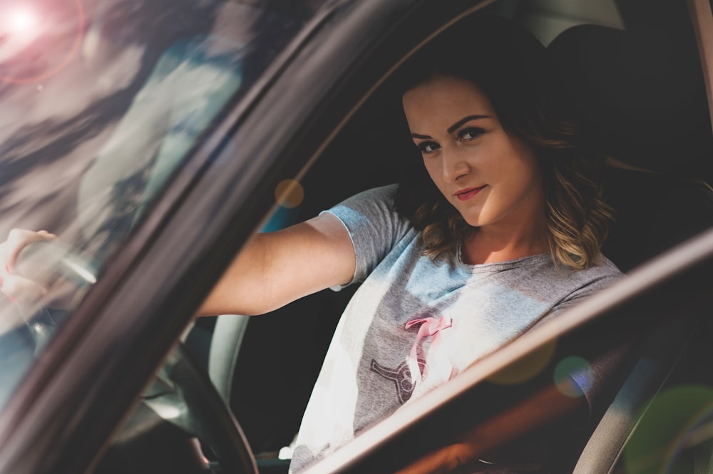 woman driving on car