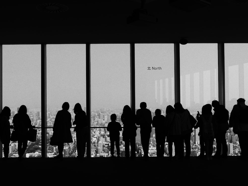 people overlooking buildings inside room