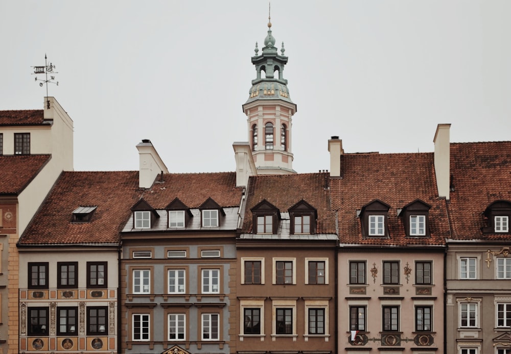 brown and white buildings under white sky