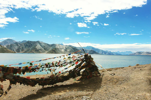 A serene shot of vibrant blue indigo tie-dye cloth hanging gently in the breeze by Erhai Lake.