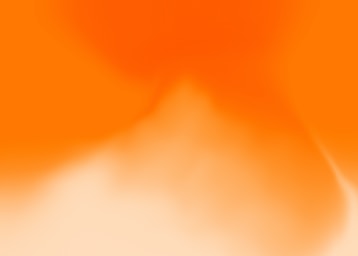 a blurry image of an orange and white background