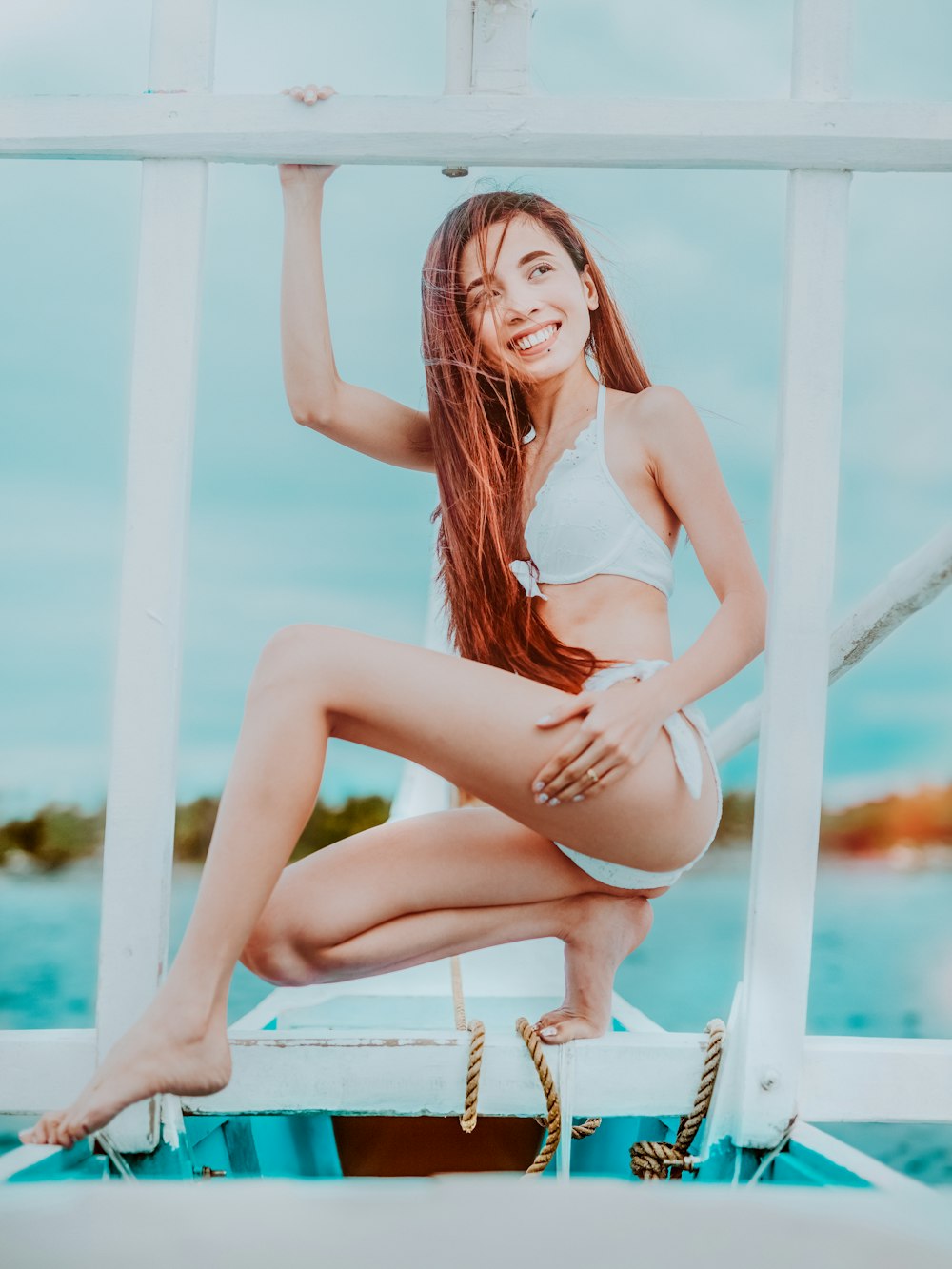 smiling woman sitting and holding railings