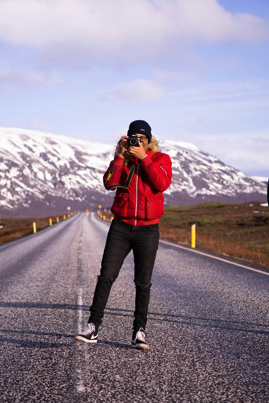 man taking photo on road