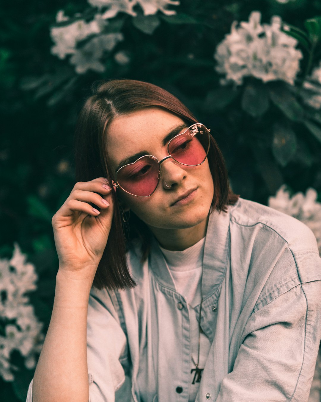 woman holding her sunglasses