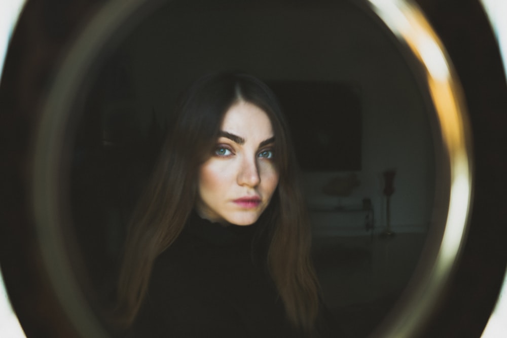 woman taking selfie in front of vanity mirror