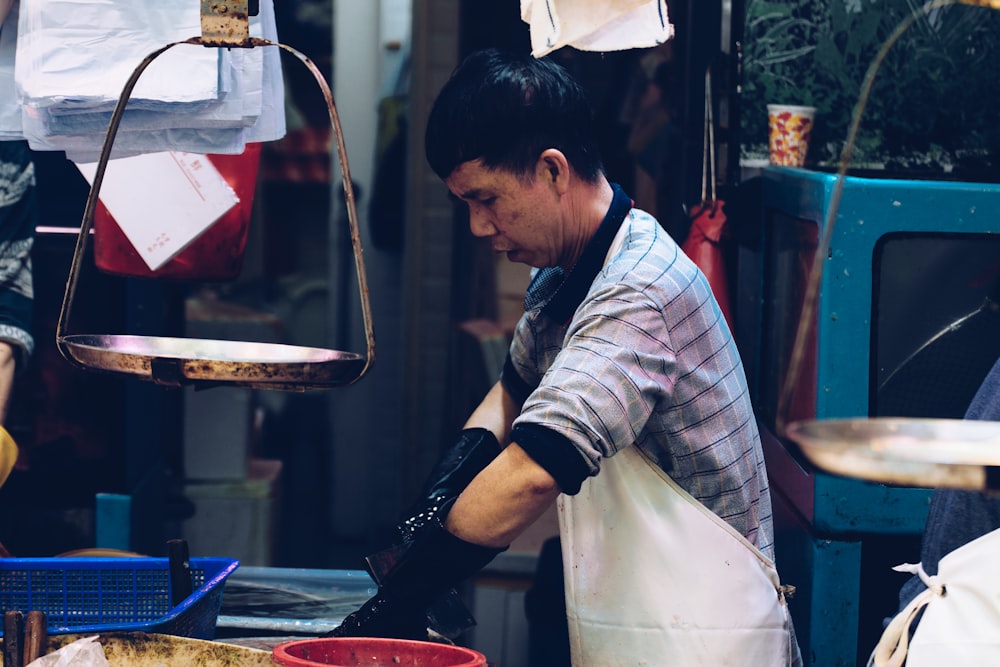 man wearing white apron