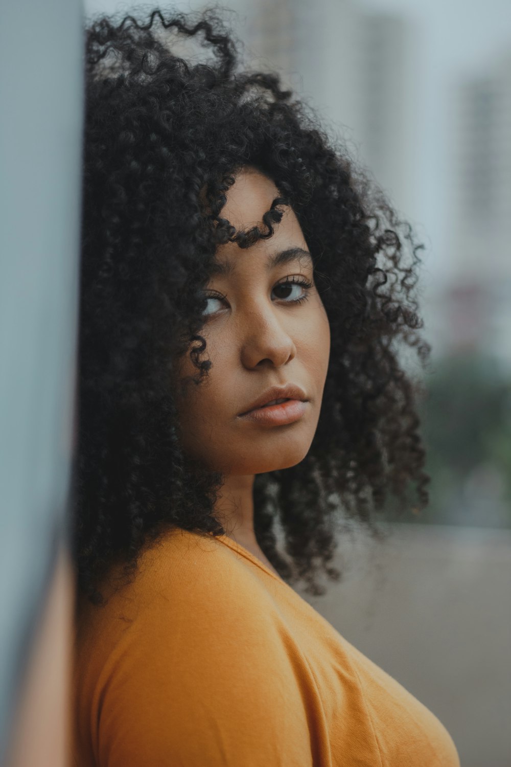 woman leaning on wall