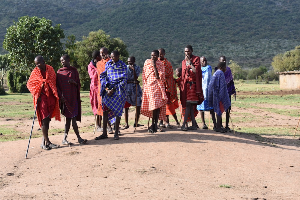 group of people standing on grass field during daytime