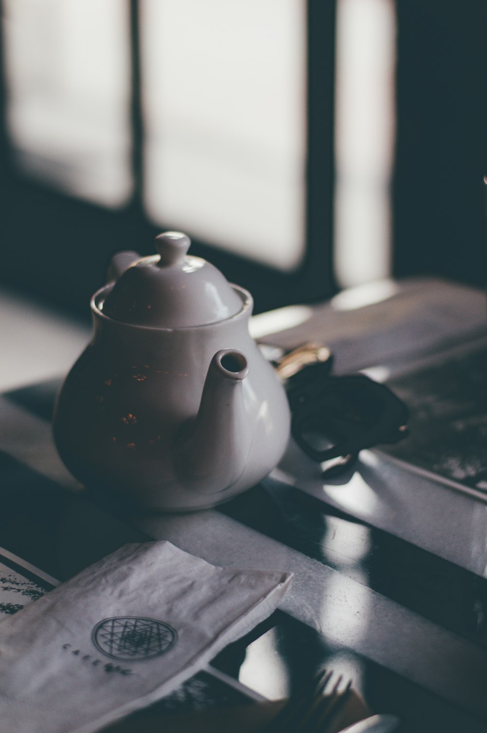 white ceramic teapot on table