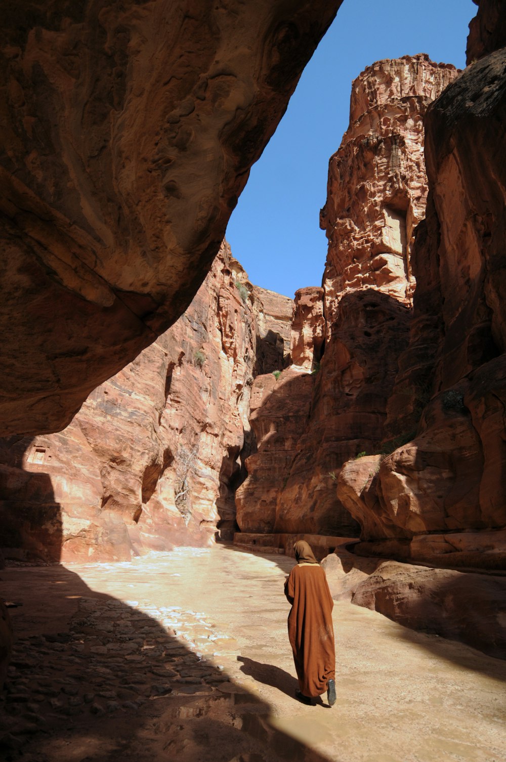 person walking between rocks