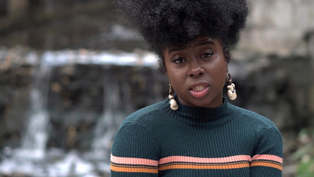 woman wearing gray sweater and earrings