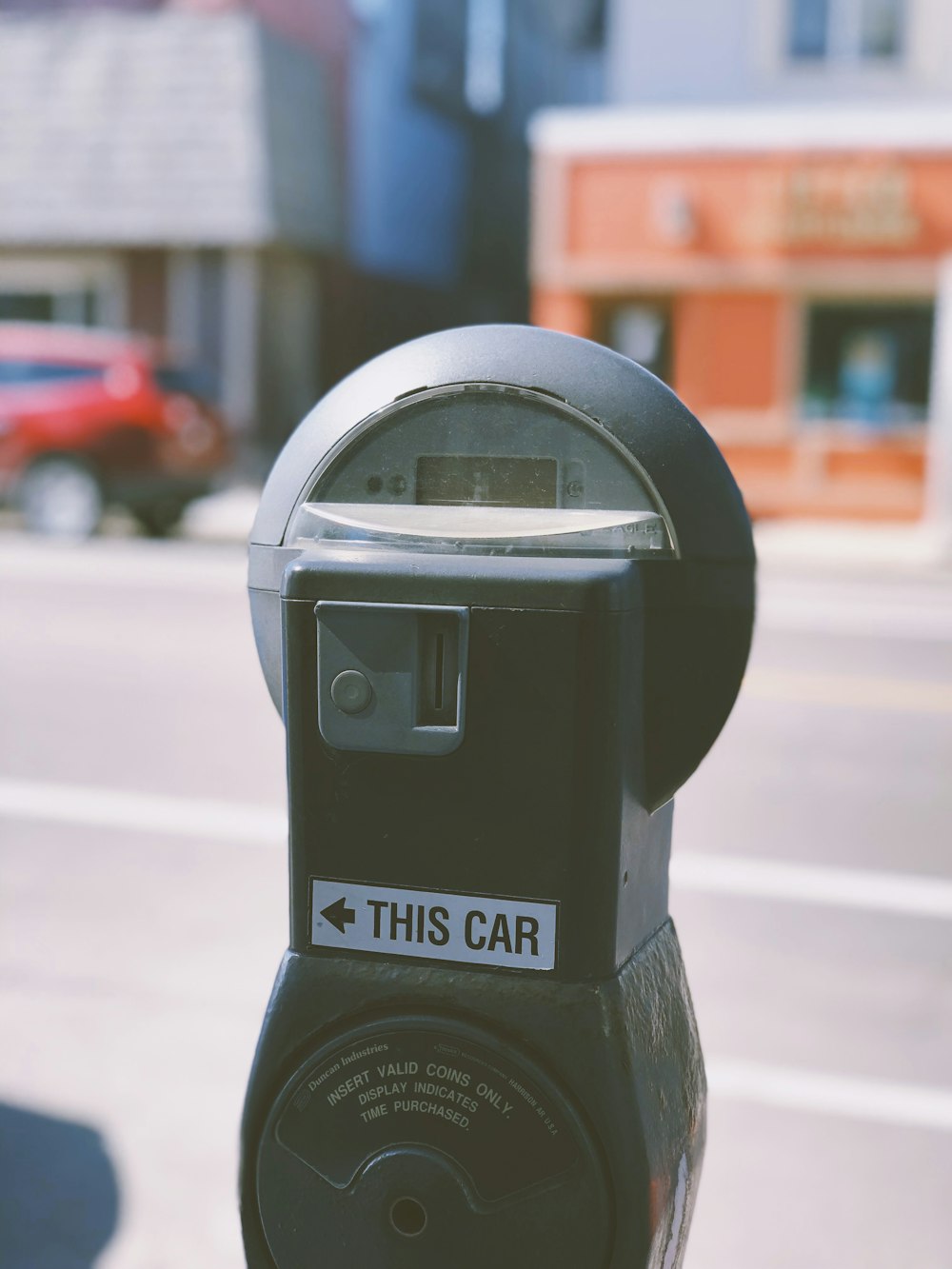 black car parking machine during daytime