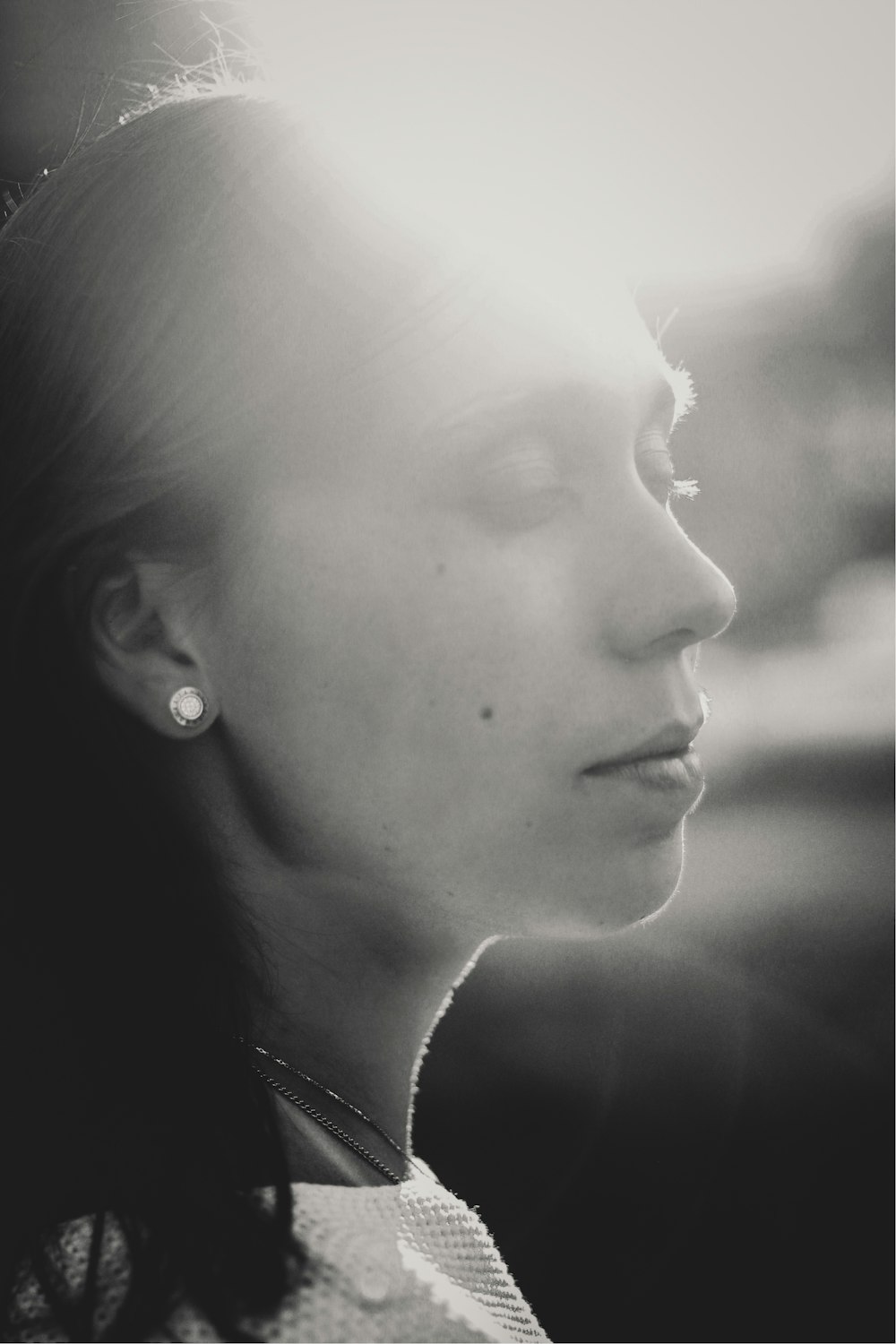 grayscale photography of woman wearing earring