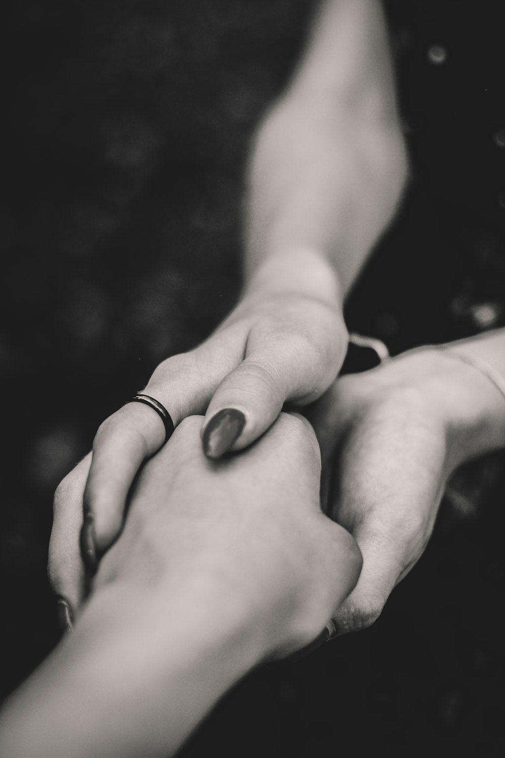selective focus of man and woman holding hands