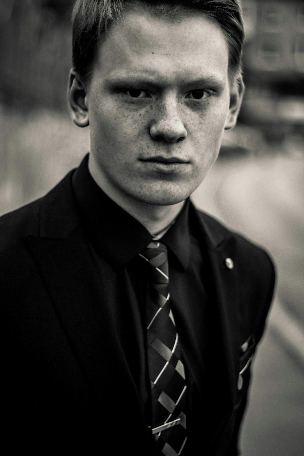 greyscale photo of man in tuxedo