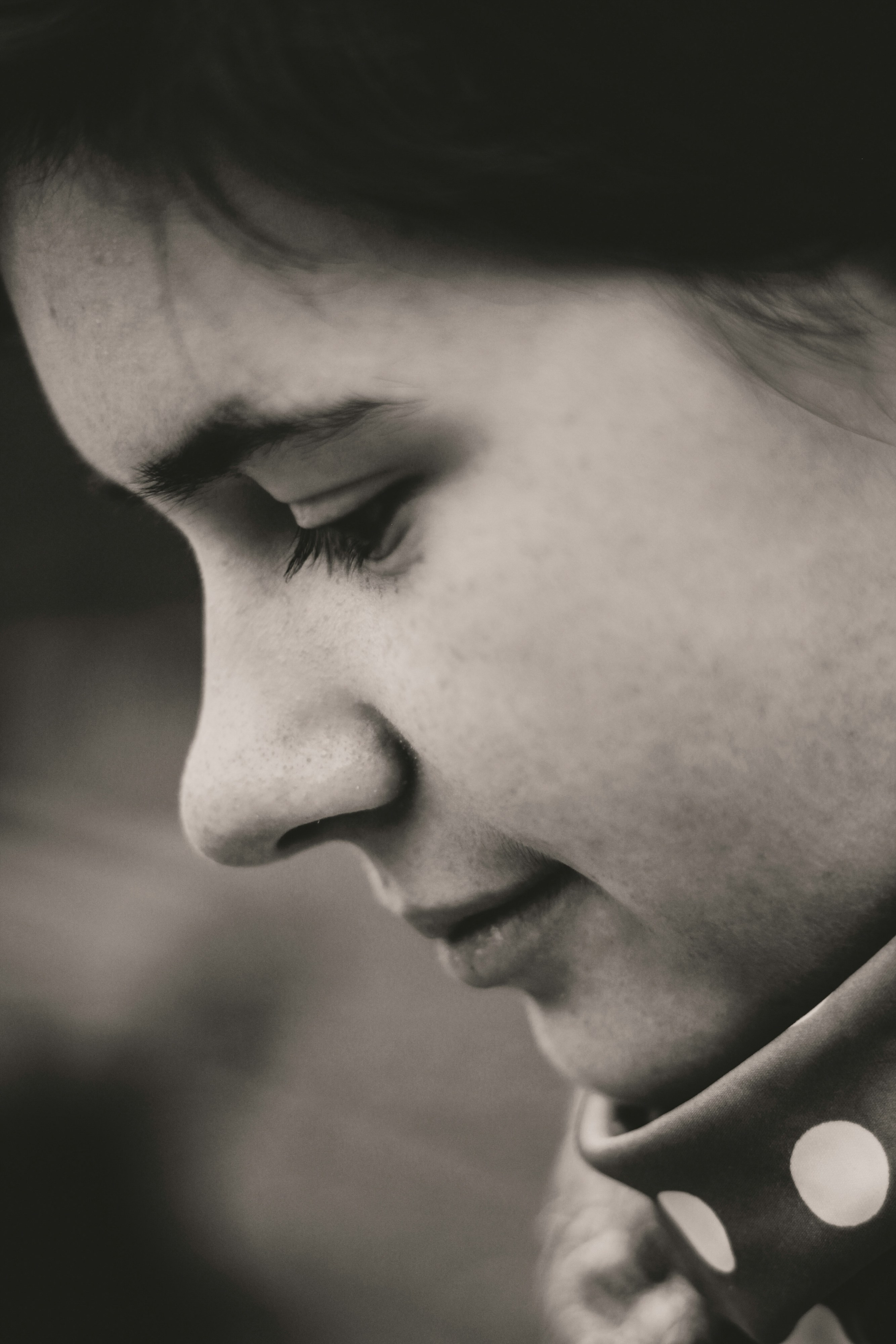 An intimate black-and-white portrait highlighting thoughtful expression and artistic flair.