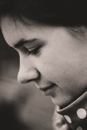 An intimate portrait capturing subtle emotion with a minimalist composition and muted tones.