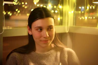 A counselor gently listening to a young person in a cozy, welcoming room.