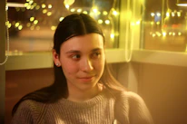 A counselor warmly listening to a young person in a cozy, inviting room.