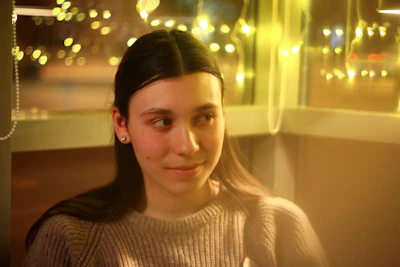 A counselor warmly listening to a young person in a cozy, inviting room.