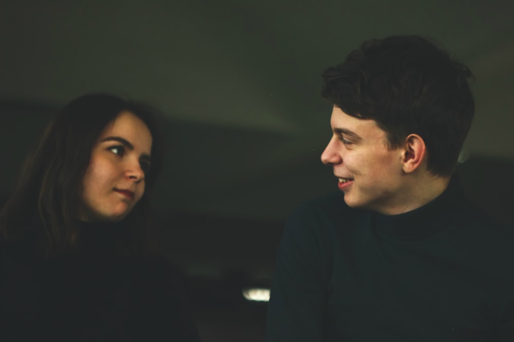 man wearing black shirt smiling at woman