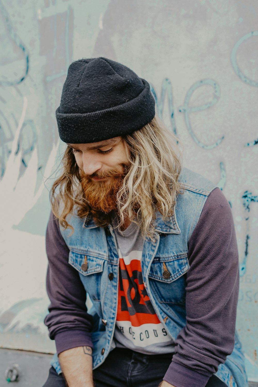 man sitting beside the wall