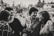 A smiling diverse group of women gathered outdoors, sharing joyful moments and inspiring each other.