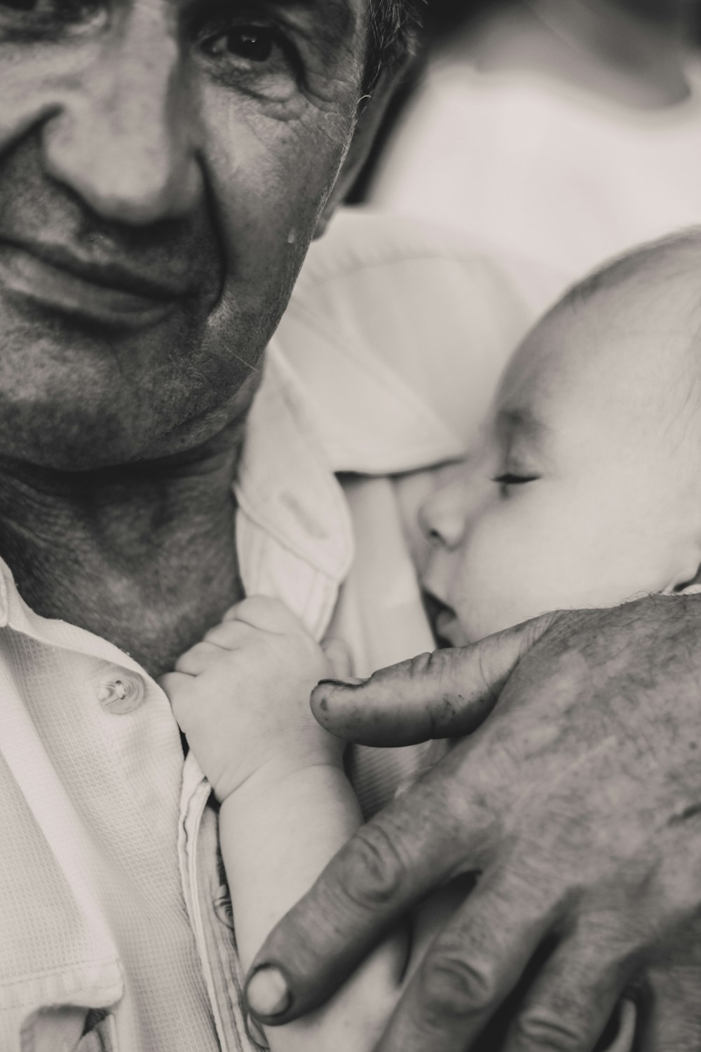 grayscale photography of man holding child