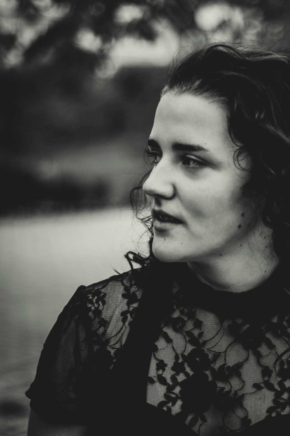 grayscale photography of woman wearing lace short-sleeved top