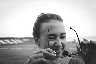 A smiling customer trying on new glasses in-store.