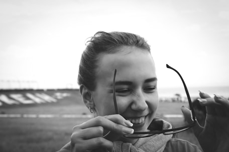 Patient smiling after cataract surgery, showing clear vision and satisfaction.