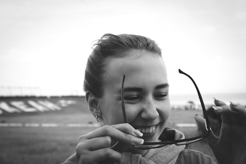 A smiling customer trying on new glasses in-store.