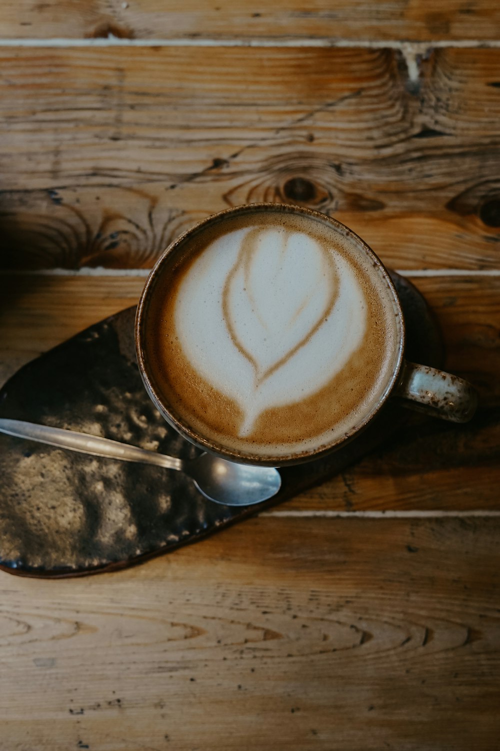 white and brown ceramic teacup