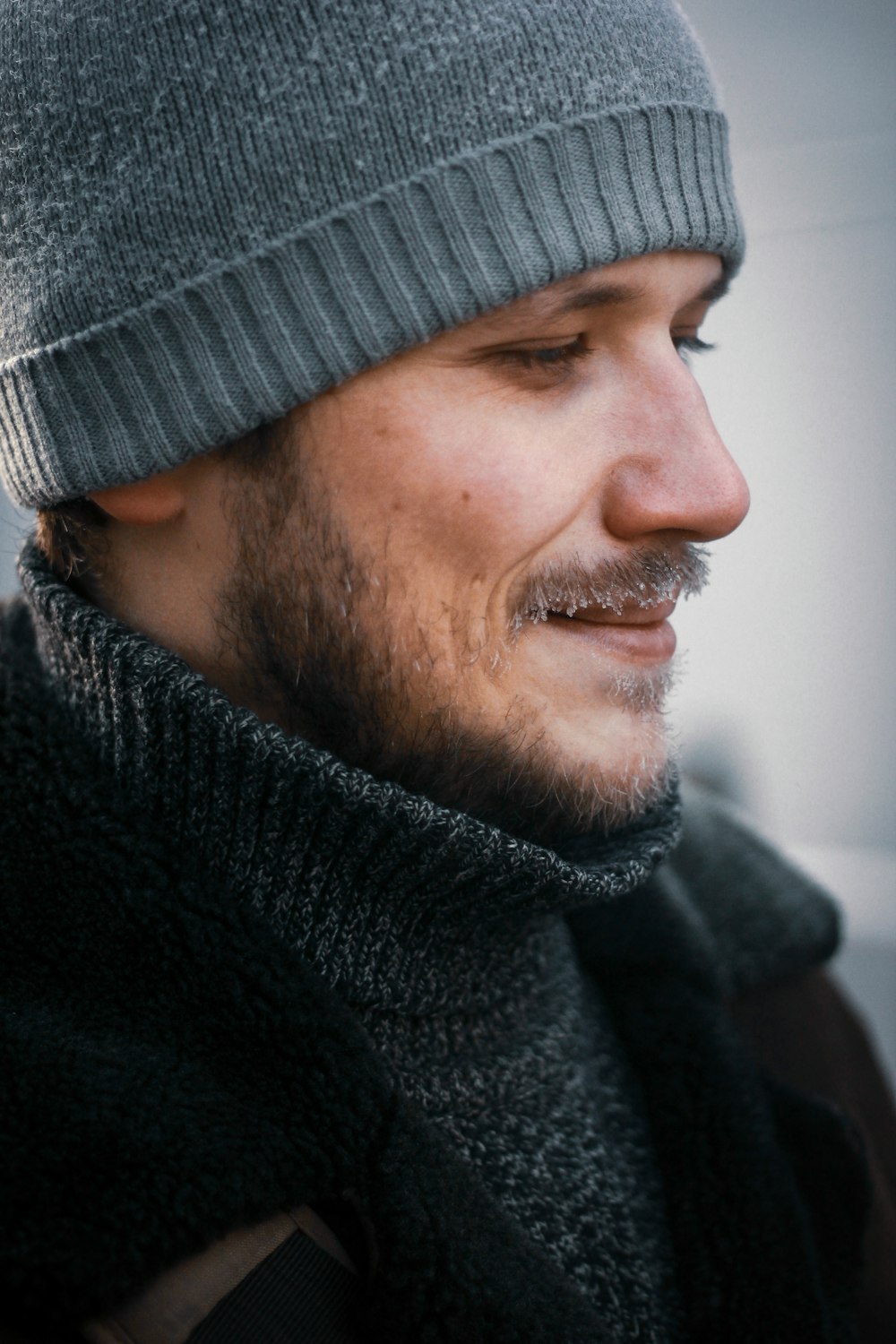 man wearing gray knit cap and black jacket