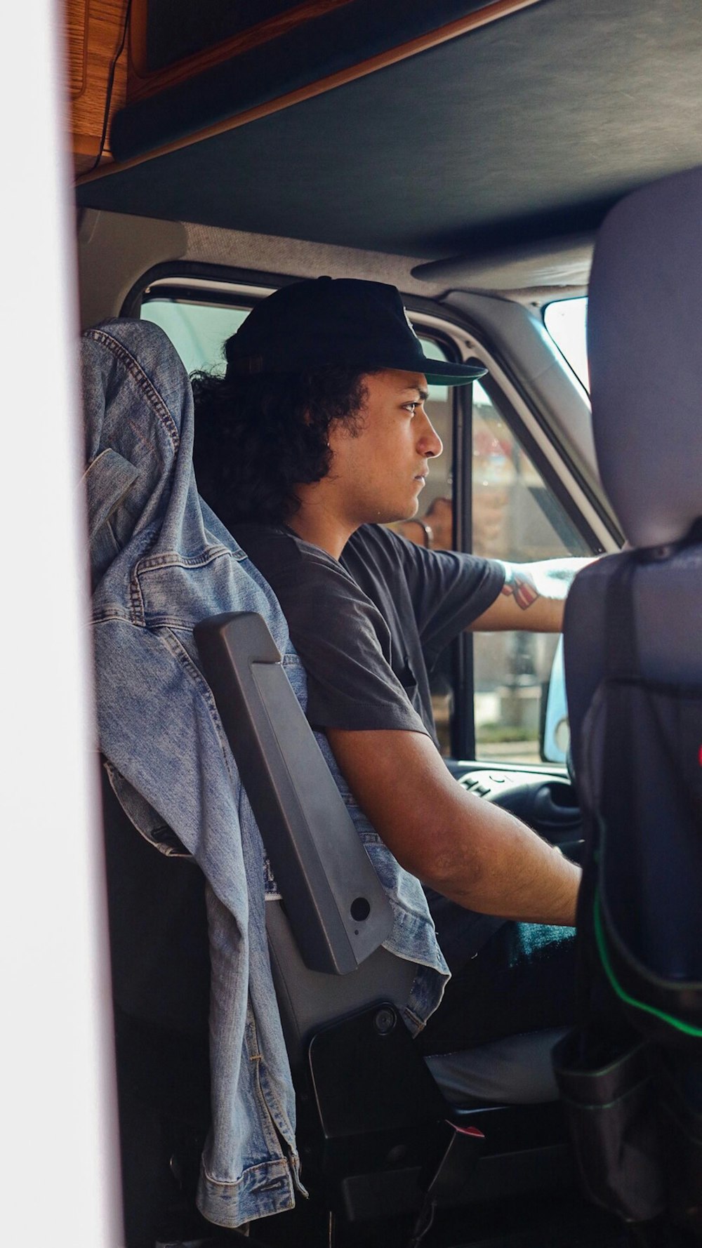 man wearing gray t-shirt driving vehicle