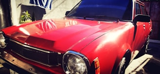 A clean and shiny car parked in a sunlit area.