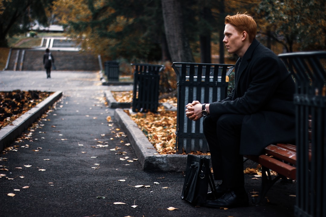 man sitting on bench during daytime