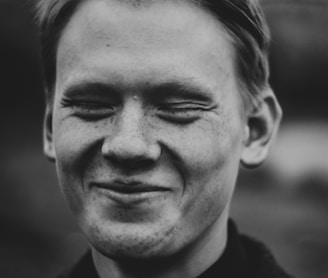 grayscale photo of smiling man
